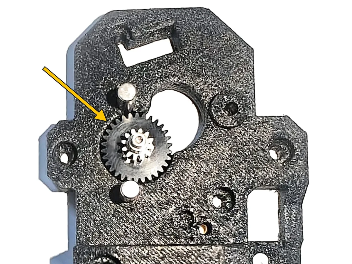 Step 4, installing the central drive gear: Fit the central drive gear (F). One end of its shaft goes into the 6×2 mm bearing (E).