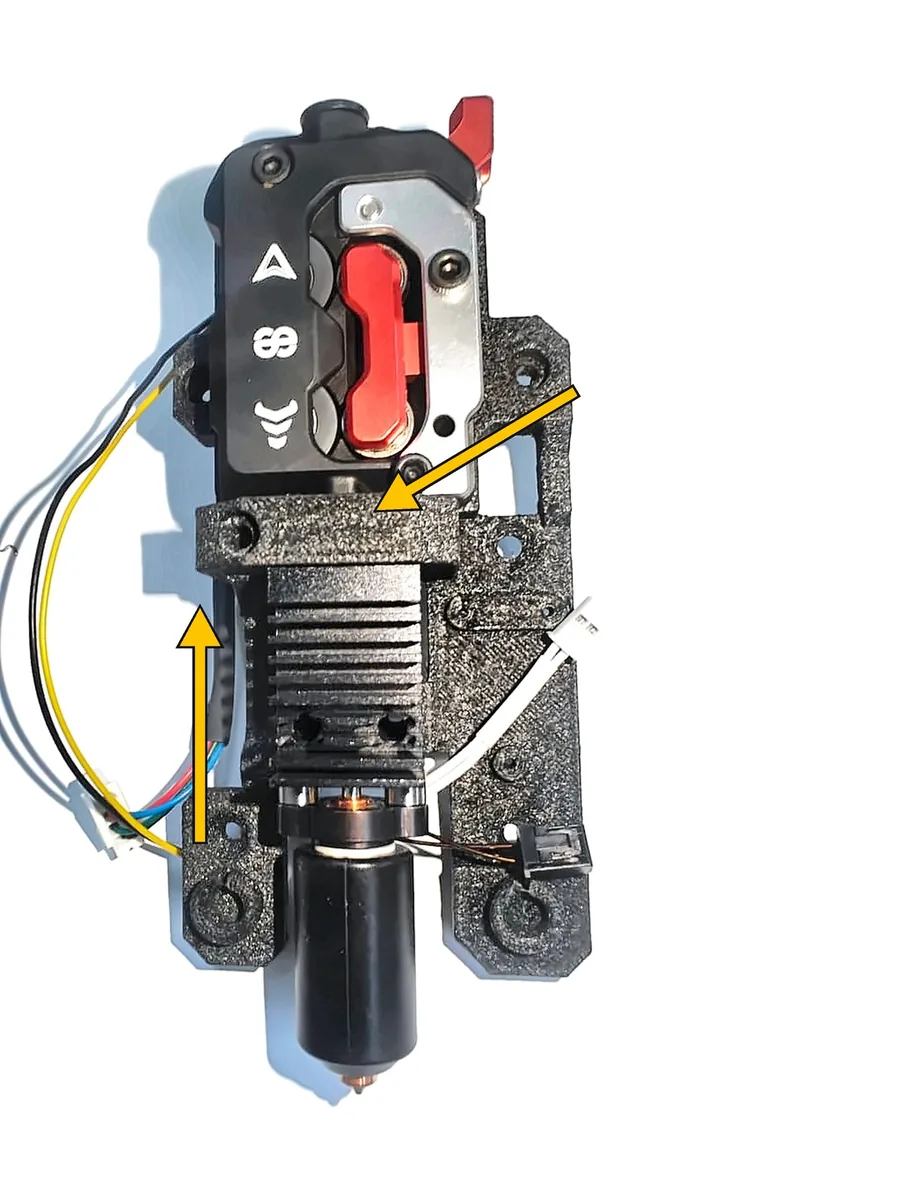 Step 18, inserting the hotend: Slide the hotend's stainless-steel throat up into the plastic clamp block.